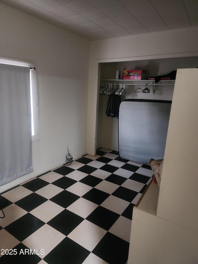 interior space featuring tile patterned floors, a closet, and heating fuel