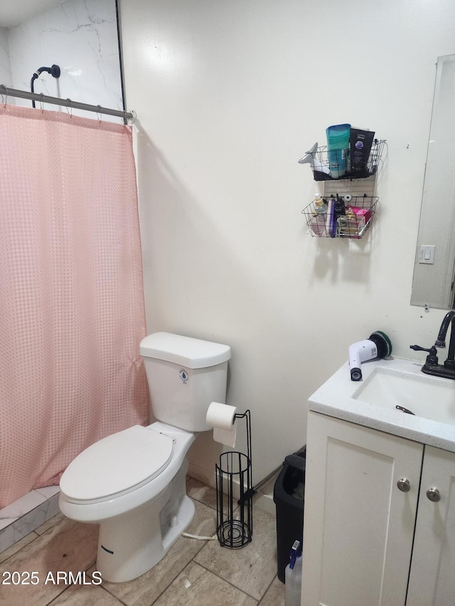 bathroom featuring a shower with shower curtain, toilet, and vanity