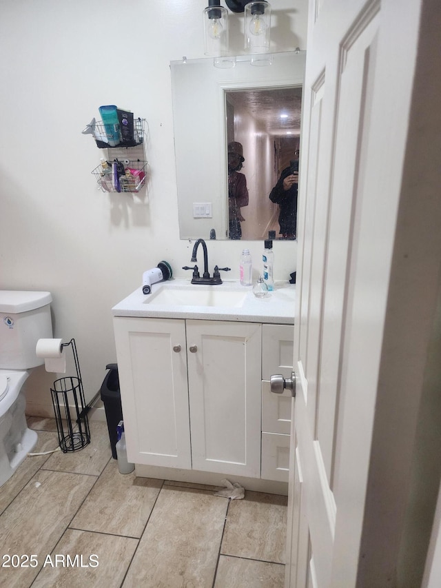 bathroom with vanity and toilet