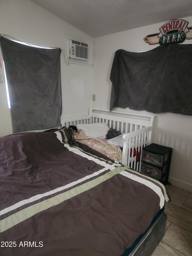 bedroom featuring a wall mounted air conditioner and lofted ceiling