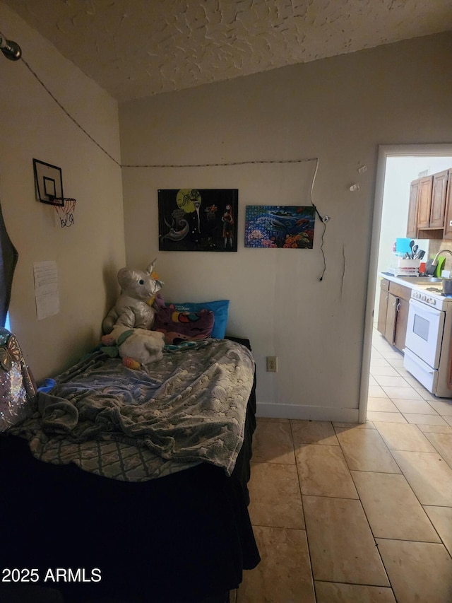 bedroom with light tile patterned floors and a sink