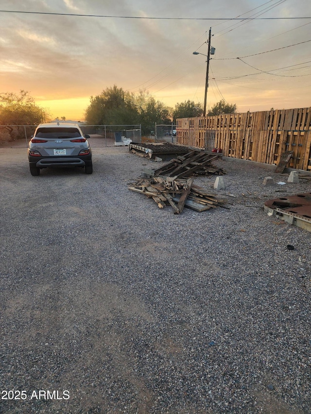 parking at dusk with fence