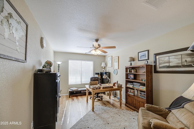 3790 W White Canyon Rd, San Tan Valley, AZ 85144 - office space featuring light wood-type flooring, a ceiling fan, a textured wall, baseboards, and a textured ceiling