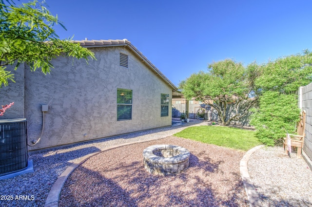 3790 W White Canyon Rd, San Tan Valley, AZ 85144 - view of yard featuring central AC and a fire pit