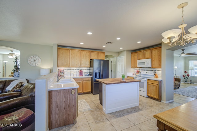 3790 W White Canyon Rd, San Tan Valley, AZ 85144 - kitchen featuring white appliances, a ceiling fan, open floor plan, a chandelier, and backsplash