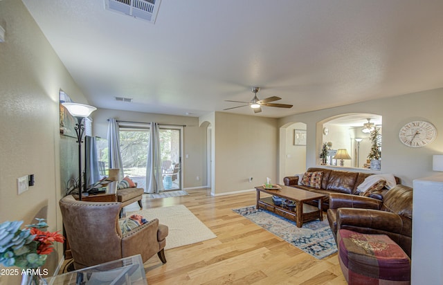 3790 W White Canyon Rd, San Tan Valley, AZ 85144 - living room with a ceiling fan, arched walkways, light wood-type flooring, and baseboards