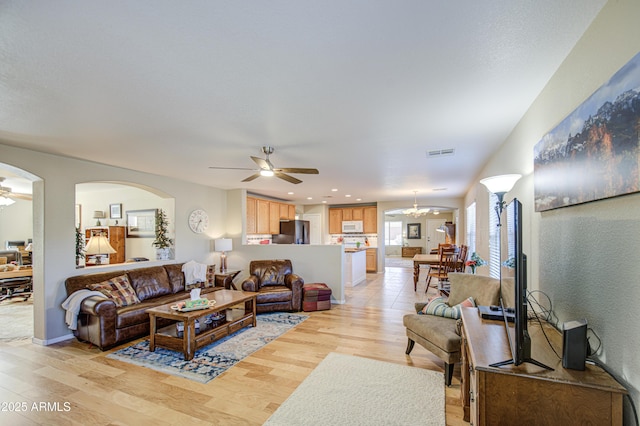 3790 W White Canyon Rd, San Tan Valley, AZ 85144 - living area featuring a ceiling fan, light wood-type flooring, arched walkways, and recessed lighting