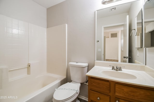 bathroom with toilet, vanity, and visible vents