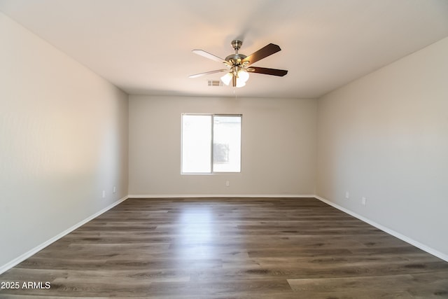 unfurnished room with a ceiling fan, baseboards, visible vents, and dark wood-type flooring