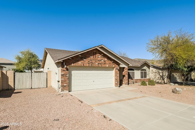 single story home featuring concrete driveway, brick siding, an attached garage, and a gate