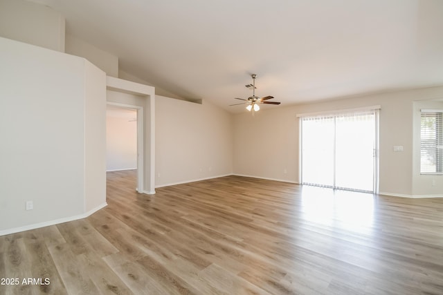 interior space featuring lofted ceiling, baseboards, light wood-style flooring, and a ceiling fan