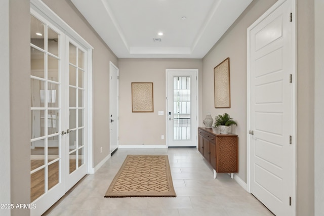 11609 W Andrew Ln, Peoria, AZ 85383 - doorway to outside with a tray ceiling, baseboards, french doors, and light tile patterned floors