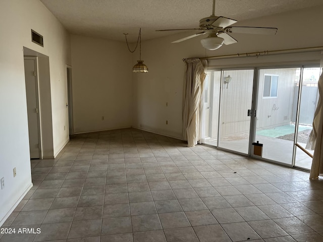 unfurnished room featuring a textured ceiling, ceiling fan, and light tile patterned flooring