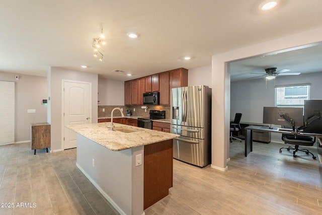 7238 N 126th Ln, Glendale, AZ 85307 - kitchen featuring black appliances, an office area, a kitchen island with sink, backsplash, and light wood-type flooring