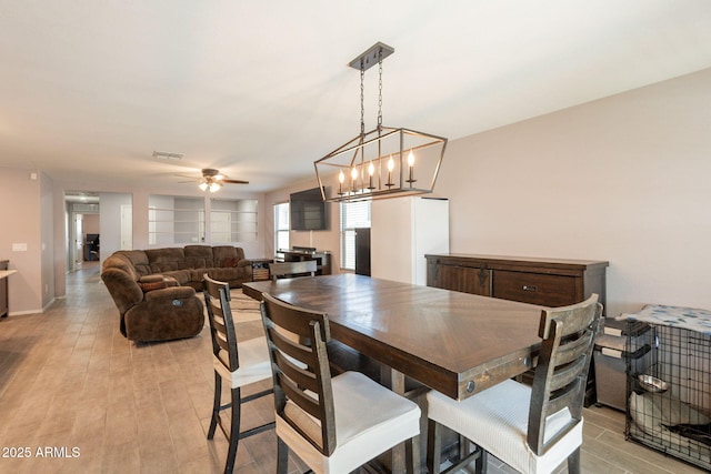 7238 N 126th Ln, Glendale, AZ 85307 - dining area featuring ceiling fan, light wood-style floors, and a chandelier