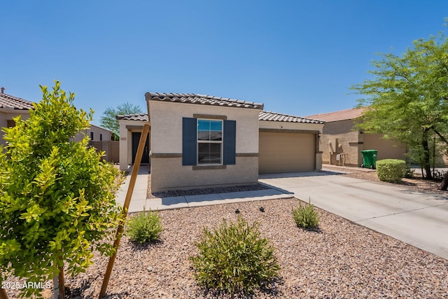 7238 N 126th Ln, Glendale, AZ 85307 - view of front of house with driveway, a tile roof, stucco siding, and an attached garage