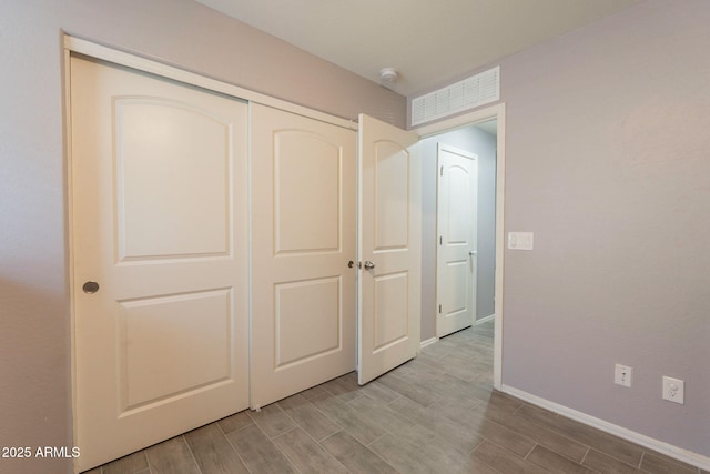 7238 N 126th Ln, Glendale, AZ 85307 - unfurnished bedroom featuring wood finished floors and a closet