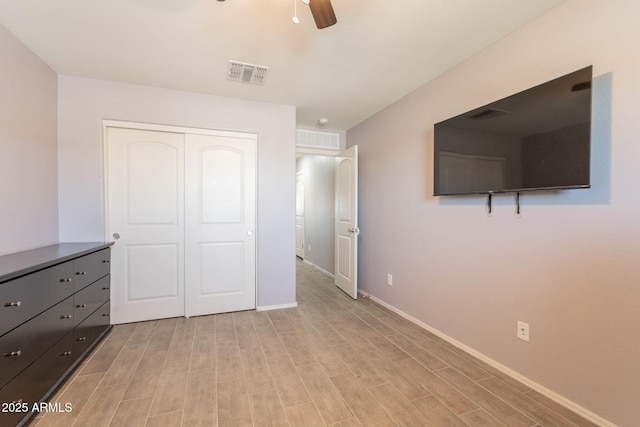 7238 N 126th Ln, Glendale, AZ 85307 - unfurnished bedroom featuring light wood-style floors, a closet, and a ceiling fan