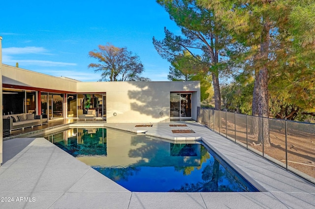 view of swimming pool featuring an outdoor living space and a patio