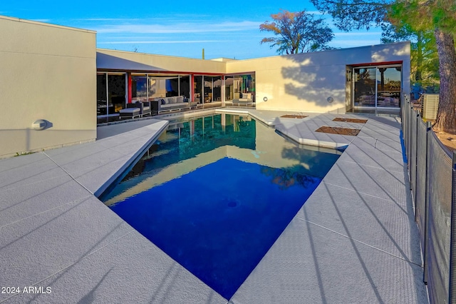 view of pool with an outdoor living space and a patio