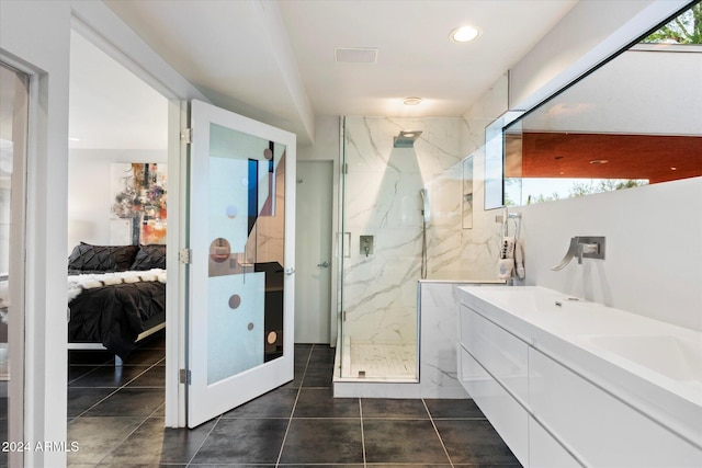 bathroom with tile patterned floors, vanity, and walk in shower