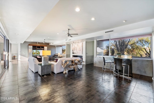 living room featuring ceiling fan and plenty of natural light