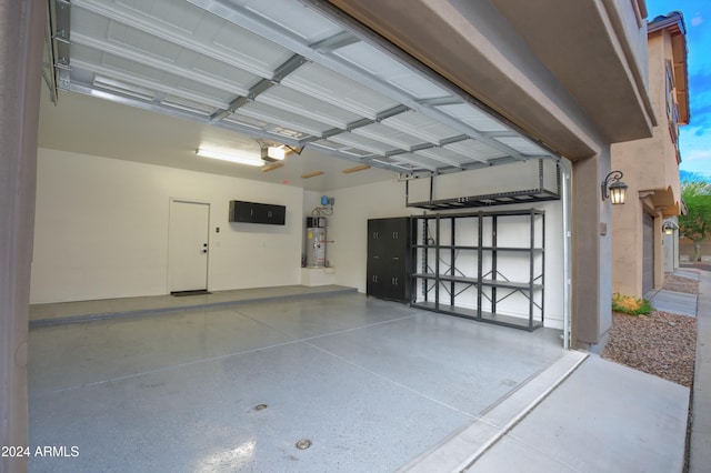 garage featuring water heater and a garage door opener