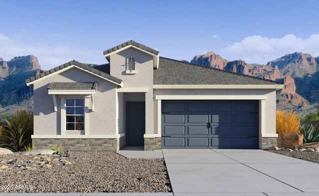 view of front of home with a mountain view and a garage