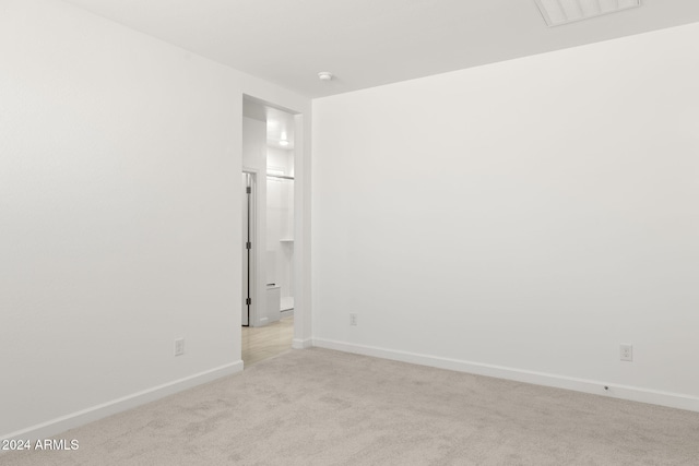 empty room featuring light colored carpet