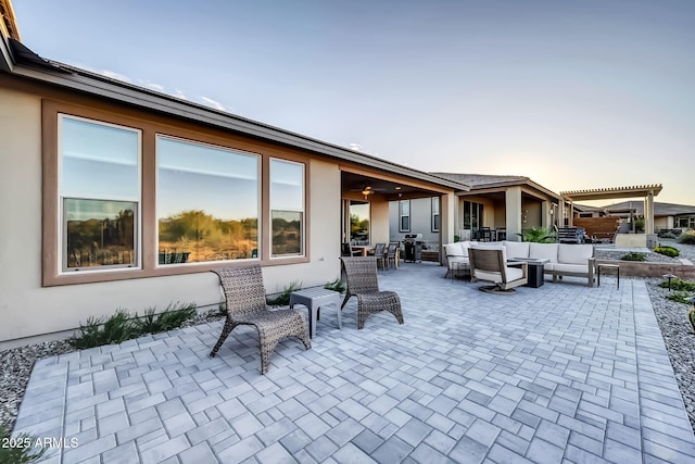 patio terrace at dusk with an outdoor living space and a pergola