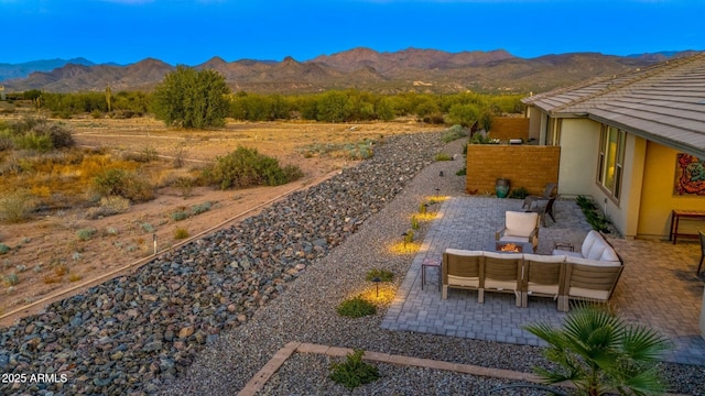 view of yard with a mountain view, an outdoor hangout area, and a patio area