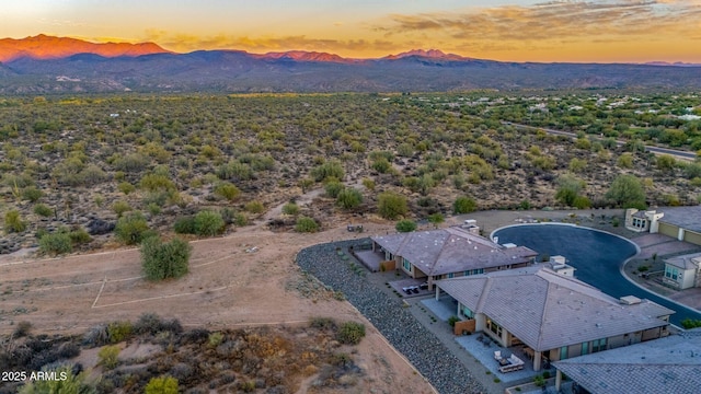 aerial view at dusk featuring a mountain view