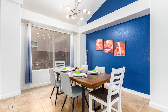 tiled dining space featuring a notable chandelier and vaulted ceiling