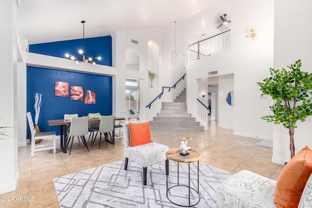 living room featuring a chandelier, high vaulted ceiling, and tile patterned floors