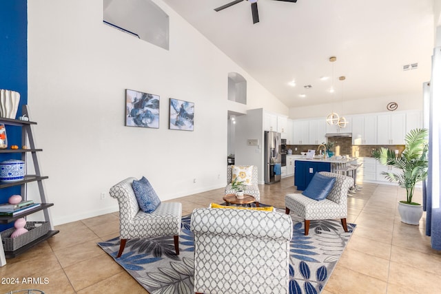 living room with sink, ceiling fan, high vaulted ceiling, and light tile patterned floors