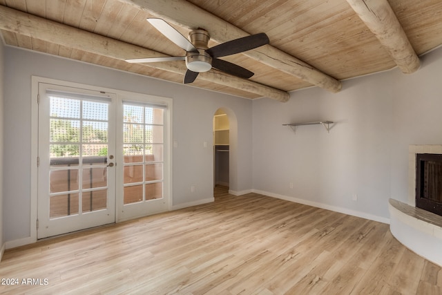 unfurnished living room featuring light hardwood / wood-style flooring, french doors, beamed ceiling, ceiling fan, and wooden ceiling