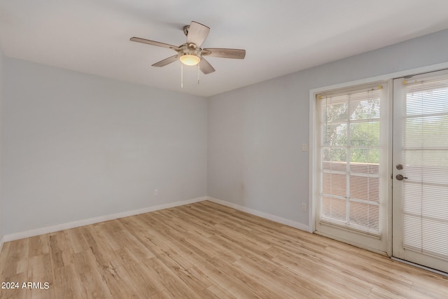 spare room featuring ceiling fan, light hardwood / wood-style floors, and french doors