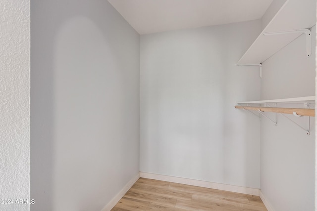 spacious closet with light hardwood / wood-style flooring