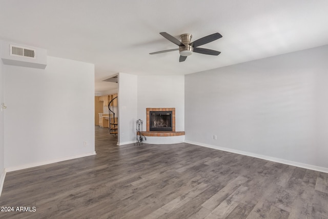 unfurnished living room featuring hardwood / wood-style flooring, a fireplace, and ceiling fan