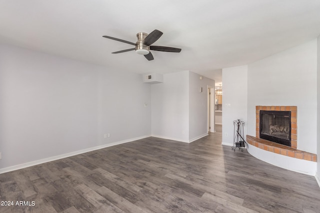 unfurnished living room featuring ceiling fan, wood-type flooring, and a tile fireplace