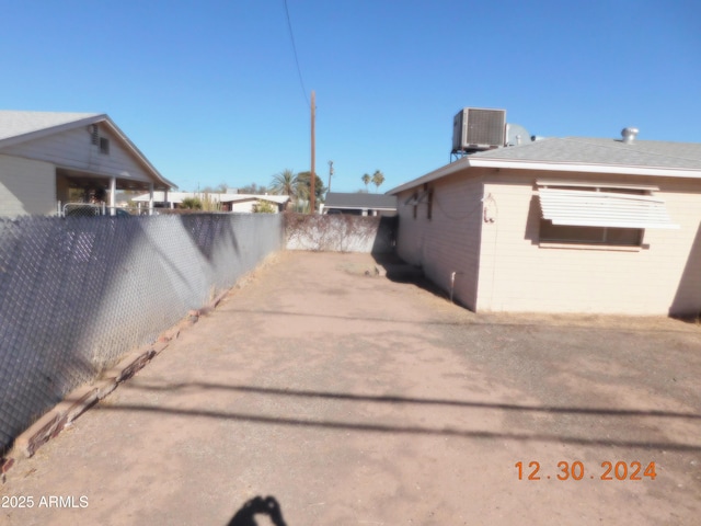 view of side of property featuring central air condition unit