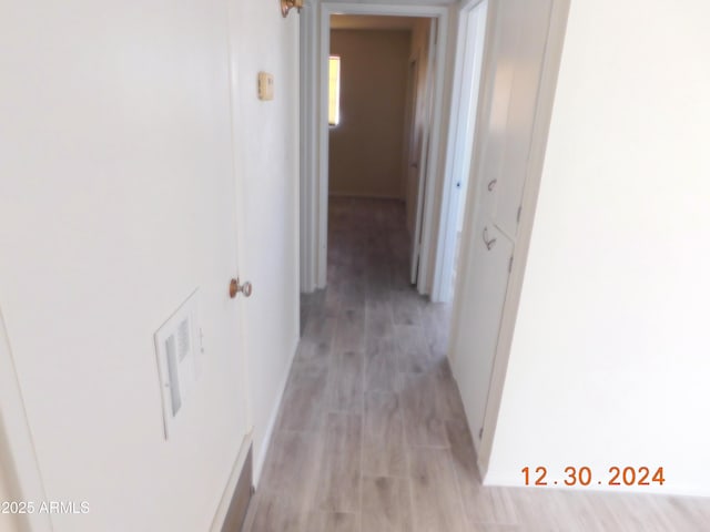 corridor with light hardwood / wood-style flooring