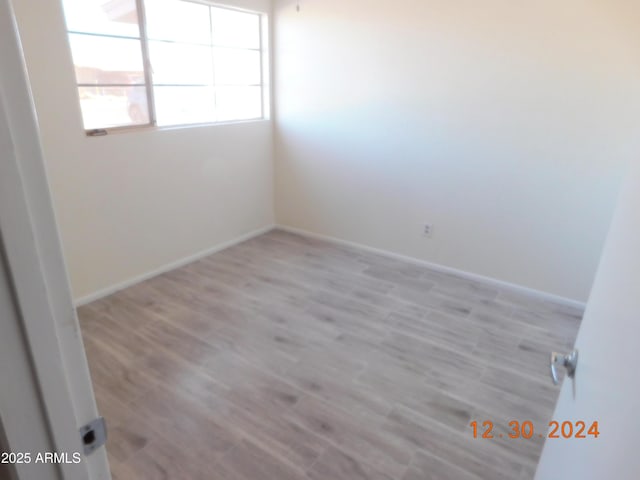 spare room featuring light hardwood / wood-style floors