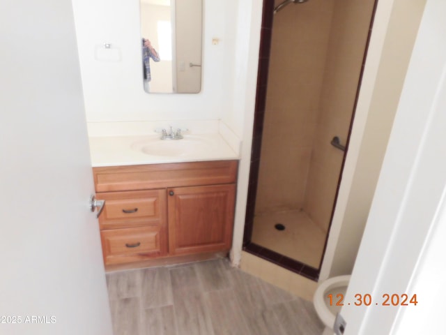 bathroom featuring a tile shower and vanity