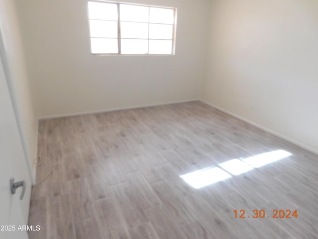 empty room with light hardwood / wood-style floors