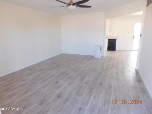 spare room featuring ceiling fan and light hardwood / wood-style floors