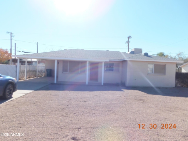 ranch-style home with a carport