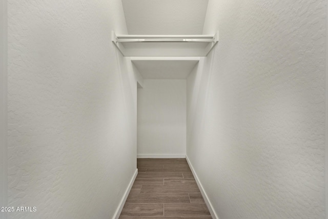 spacious closet with wood finish floors