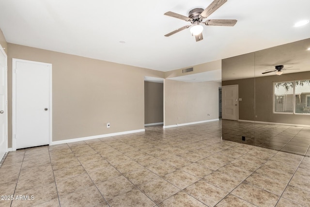 2645 W Elm St, Phoenix, AZ 85017 - spare room with a ceiling fan, light tile patterned floors, and baseboards