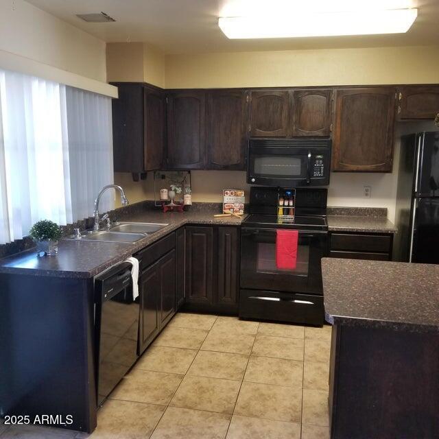 2645 W Elm St, Phoenix, AZ 85017 - kitchen featuring black appliances, a sink, dark countertops, and dark brown cabinets